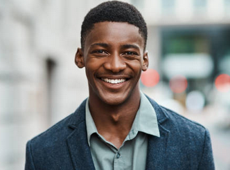 Young black man smiling in a professional suit